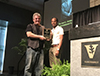 Graduate student Mark Crowder, right, presents the Teacher of the Year Award to Ronald Emeson, Ph.D., at last week’s 26th annual Joel G. Hardman Student-Invited Pharmacology Forum. Emeson is now a three-time winner of the award; he previously received it in 2003 and in 1995, the first year it was awarded.
